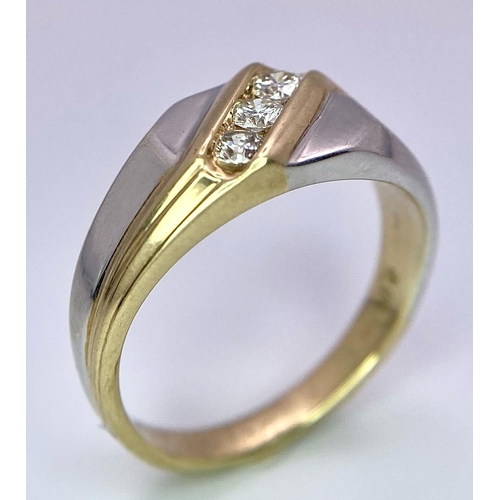 1704 - A 9K Yellow and White Gold Ring - Diagonally channel set with three round brilliant cut diamonds. Bo... 