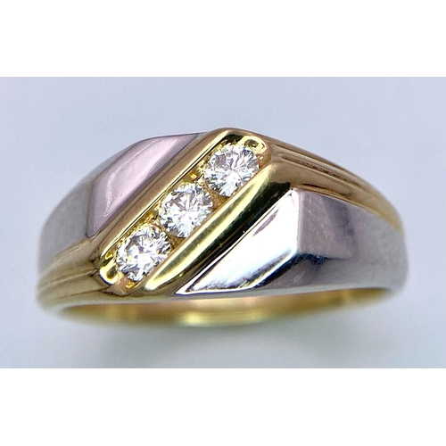 1704 - A 9K Yellow and White Gold Ring - Diagonally channel set with three round brilliant cut diamonds. Bo... 