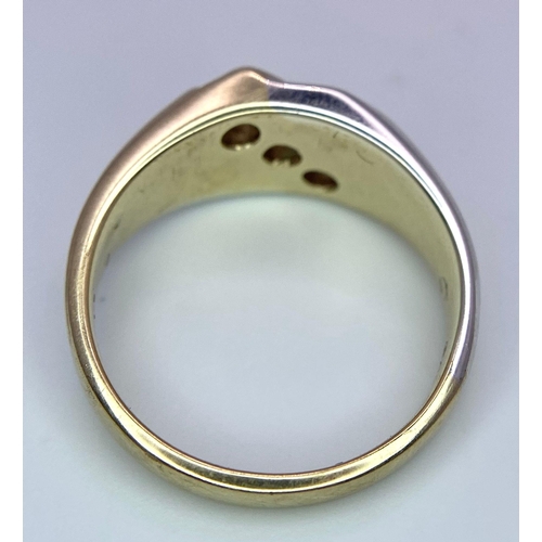 1704 - A 9K Yellow and White Gold Ring - Diagonally channel set with three round brilliant cut diamonds. Bo... 