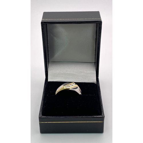 1704 - A 9K Yellow and White Gold Ring - Diagonally channel set with three round brilliant cut diamonds. Bo... 