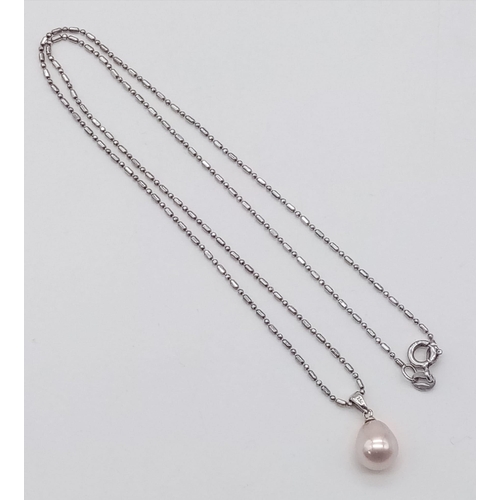 1078 - A sterling silver chain necklace with a tear drop shaped natural pearl pendant. Chain length: 44 cm,... 