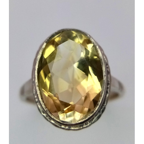 1083 - A Vintage Silver and Large Oval Cut Citrine Set Ring Size P. The Ring is set with a 1.5cm Long Oval ... 