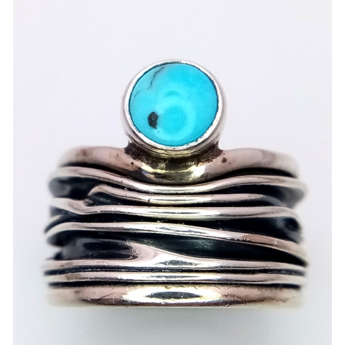 1090 - A Sterling Silver Mexican Turquoise Set Bark Pattern. Ring size L. The ring measures 1.7cm wide at t... 