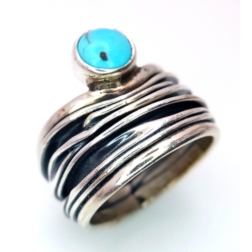 1090 - A Sterling Silver Mexican Turquoise Set Bark Pattern. Ring size L. The ring measures 1.7cm wide at t... 