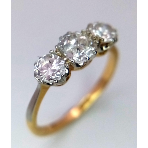 13 - An 18 k yellow gold ring with a trilogy of brilliant round cut diamonds (1 carat min.), ring size: L... 