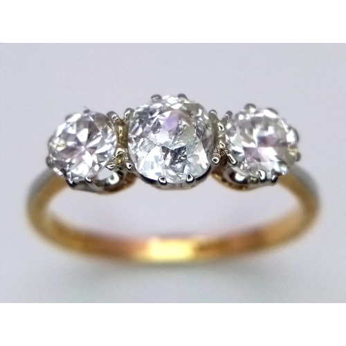 13 - An 18 k yellow gold ring with a trilogy of brilliant round cut diamonds (1 carat min.), ring size: L... 