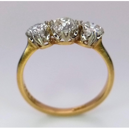 13 - An 18 k yellow gold ring with a trilogy of brilliant round cut diamonds (1 carat min.), ring size: L... 