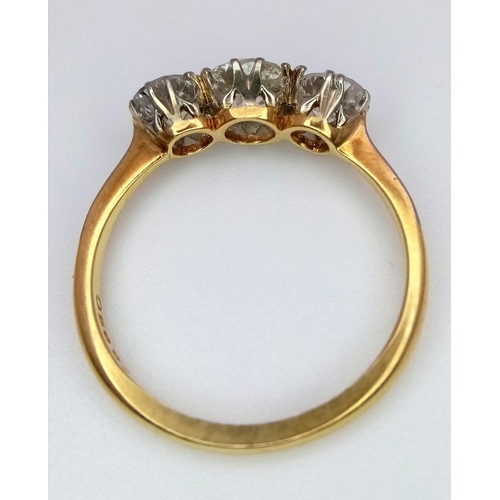 13 - An 18 k yellow gold ring with a trilogy of brilliant round cut diamonds (1 carat min.), ring size: L... 