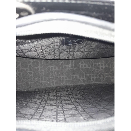 144 - A Christian Dior - Lady Dior Bag. Canvas and black patent leather exterior. Silver tone hardware. Mo... 