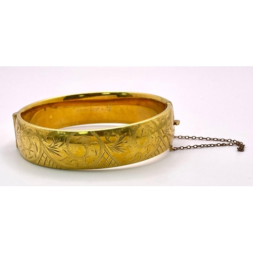 1575 - A vintage 9Ct gold metal cored adjustable click-on bangle with nicely ornate decoration. Total weigh... 