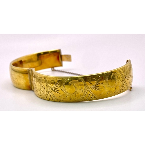 1575 - A vintage 9Ct gold metal cored adjustable click-on bangle with nicely ornate decoration. Total weigh... 