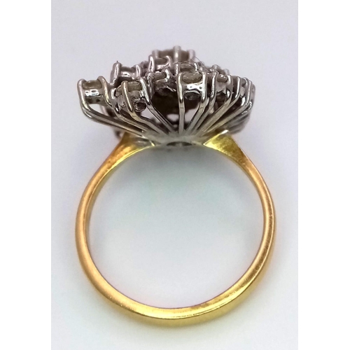 169 - An 18K Yellow Gold and Diamond Swirl Ring. A central brilliant round cut diamond surrounded by two s... 