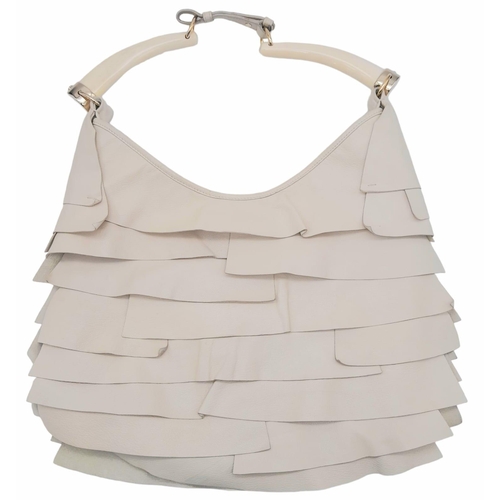 193 - A YSL Saint-Tropez Leather Double Horn Hobo Bag. Ivory leather strip exterior. Horn shaped handles. ... 