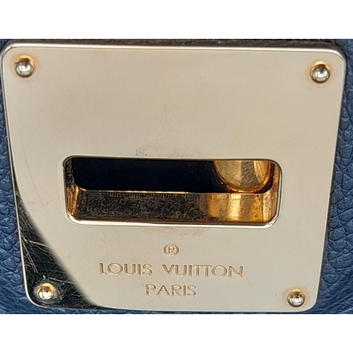 200 - A Louis Vuitton Monogram Empreinte PM Tote Bag. Navy blue exterior with gold tone hardware. Spacious... 