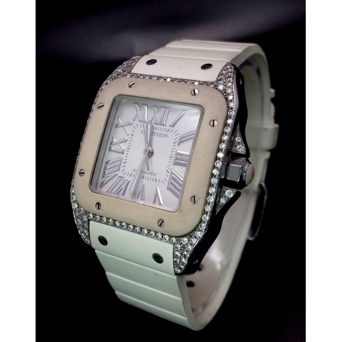 25 - A Cartier Santos 100 Automatic Unisex Diamond Watch. White rubber Cartier strap with diamond buckle.... 