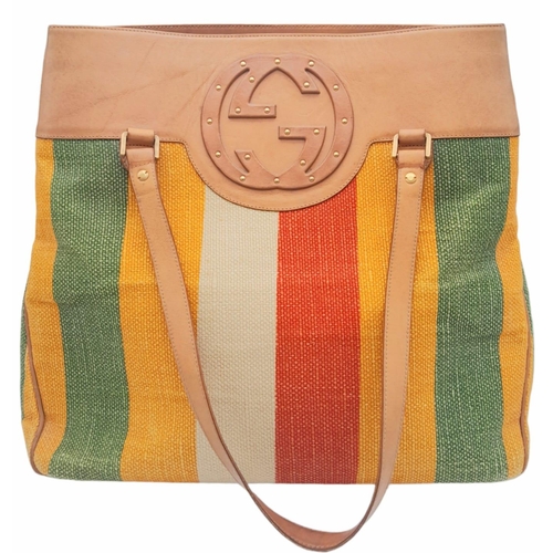 256 - A Gucci Baiadera Canvas and Leather Tote Bag. Multi coloured canvas exterior with a large Gucci mono... 