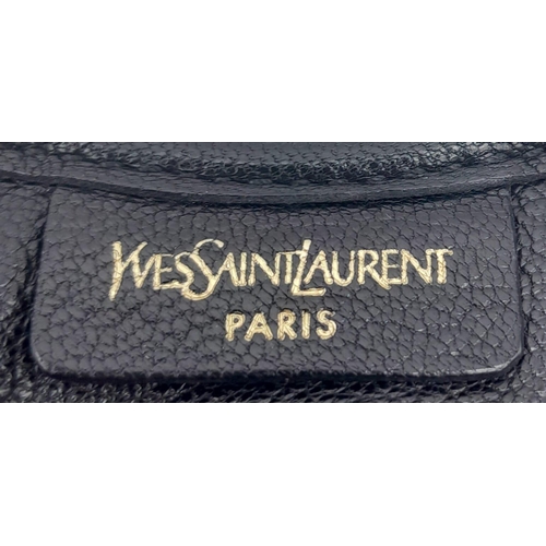 263 - A YSL Saint-Tropez Handbag. Black leather strip exterior. Horn shaped handle. Textile interior with ... 