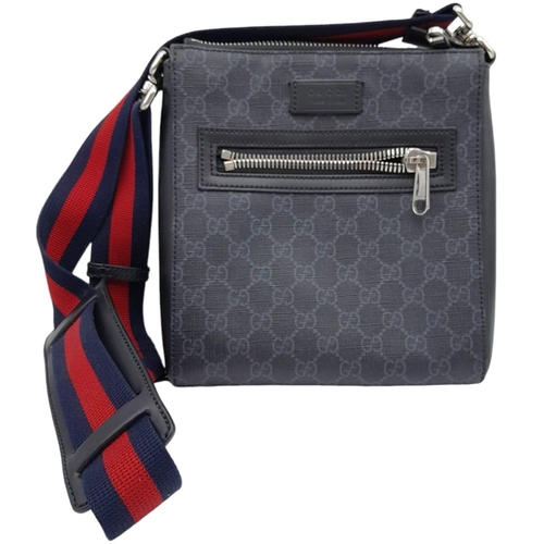 270 - A Gucci Monogram Messenger Bag. GG grey canvas exterior wit black leather accents and zipped compart... 