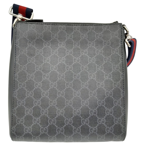 270 - A Gucci Monogram Messenger Bag. GG grey canvas exterior wit black leather accents and zipped compart... 