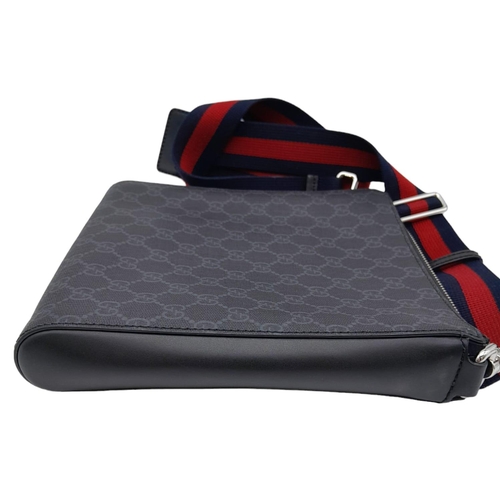 270 - A Gucci Monogram Messenger Bag. GG grey canvas exterior wit black leather accents and zipped compart... 