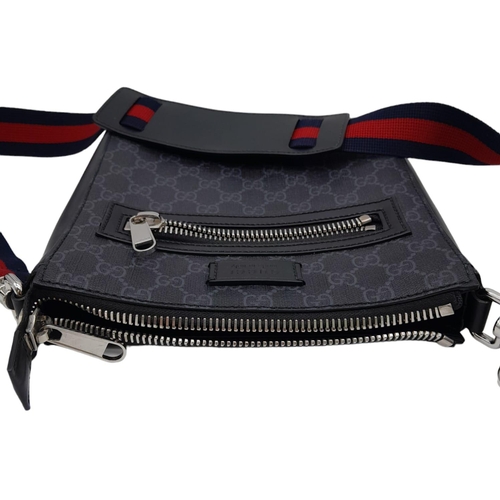 270 - A Gucci Monogram Messenger Bag. GG grey canvas exterior wit black leather accents and zipped compart... 