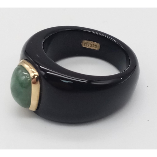 290 - An Unworn Rare Black Resin Encased 9 Carat Yellow Gold Jade Set Ring Size M. The Ring is set with 9m... 