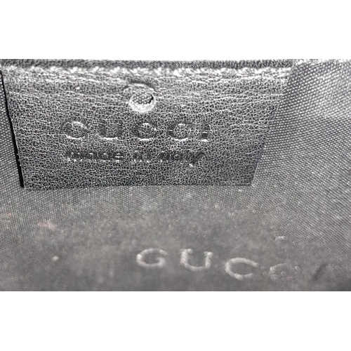 347 - A Gucci Black Leather Flap Hand Bag. Silver-tone hardware. Black textile interior with zipped compar... 