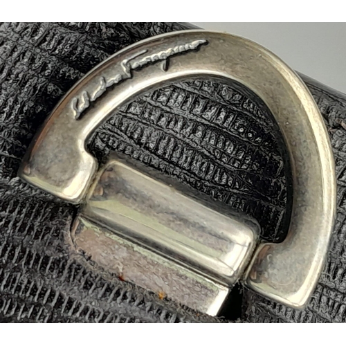 375 - A Salvatore Ferragamo Black leather Document Bag. Textured exterior with combination lock. Textile i... 