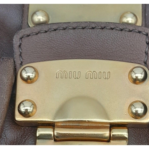 382 - A Miu Miu Brown Leather Handbag. Ruffled leather exterior with two pocketed compartments. Gold tone ... 