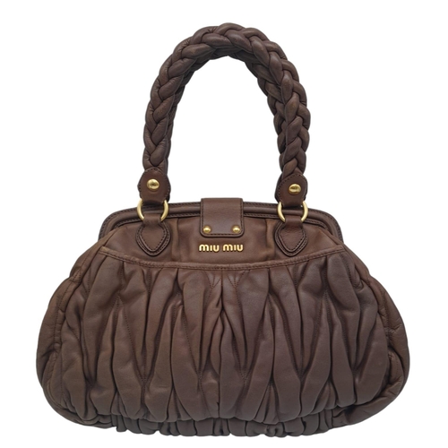 382 - A Miu Miu Brown Leather Handbag. Ruffled leather exterior with two pocketed compartments. Gold tone ... 