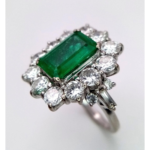 39 - A Head-Turning 18K White Gold, Emerald and Diamond Ladies Dress Ring. Rectangular emerald with a 12 ... 