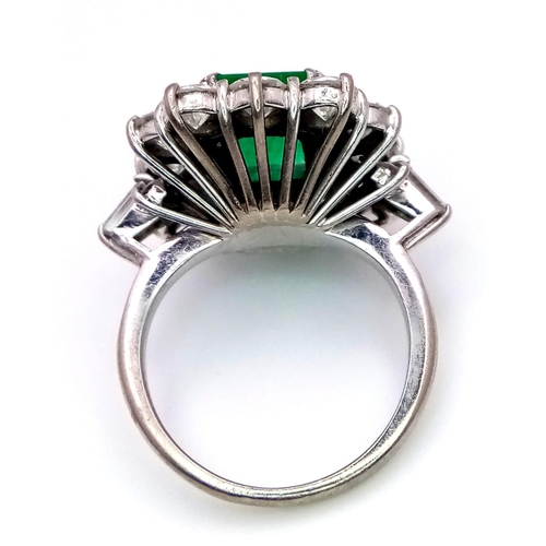 39 - A Head-Turning 18K White Gold, Emerald and Diamond Ladies Dress Ring. Rectangular emerald with a 12 ... 