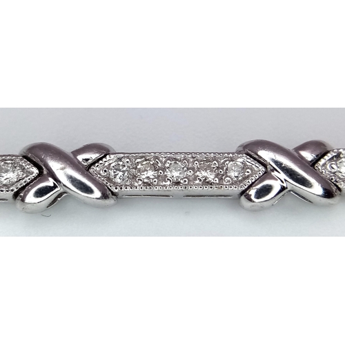 46 - An 18K White Gold and Diamond Bar Link Necklace. 1.24ctw of diamonds. Love-knot separators. 43cm len... 