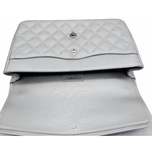 53 - A Chanel Metallic Silver Double Flap Jumbo Bag. Quilted caviar leather. Silver tone hardware. Double... 