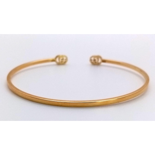 99 - An 18K Yellow Gold Gucci Designer Cuff Bangle. Comes with a variety of plush Gucci packaging items. ... 