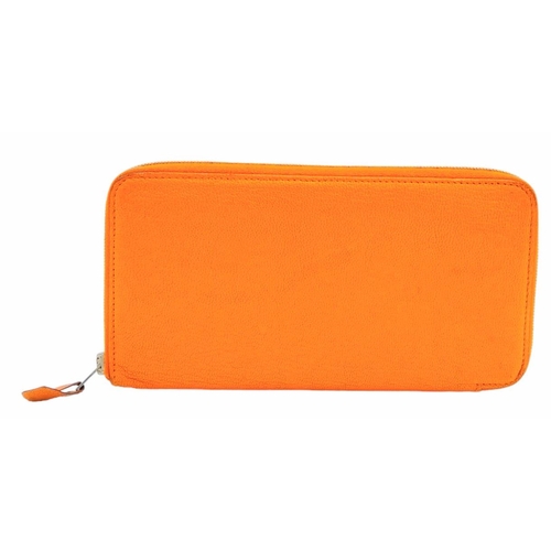 452 - A Hermes Burnt Orange Leather Wallet. Burnt orange leather interior with zipped and open compartment... 