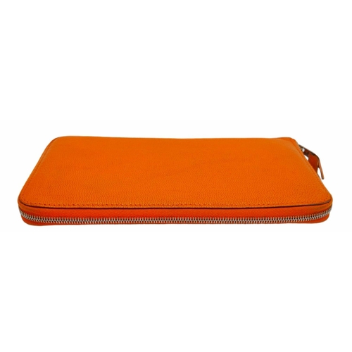 452 - A Hermes Burnt Orange Leather Wallet. Burnt orange leather interior with zipped and open compartment... 