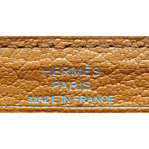 452 - A Hermes Burnt Orange Leather Wallet. Burnt orange leather interior with zipped and open compartment... 