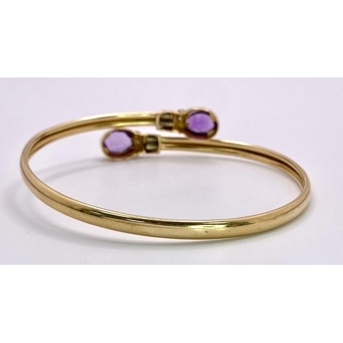 391 - A 9K yellow gold diamond and amethyst torque bangle.7g, 6cm diameter (amy:1.70ct/dia:0.01ct)

ref: S... 