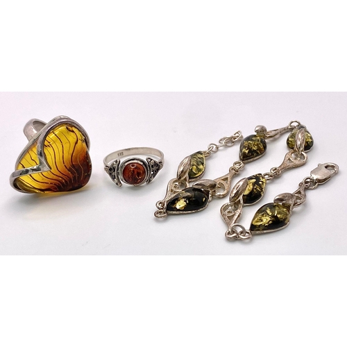 983 - A Sterling silver selection of 3 amber pieces, including 2 rings and a bracelet, 17.6g collective we... 