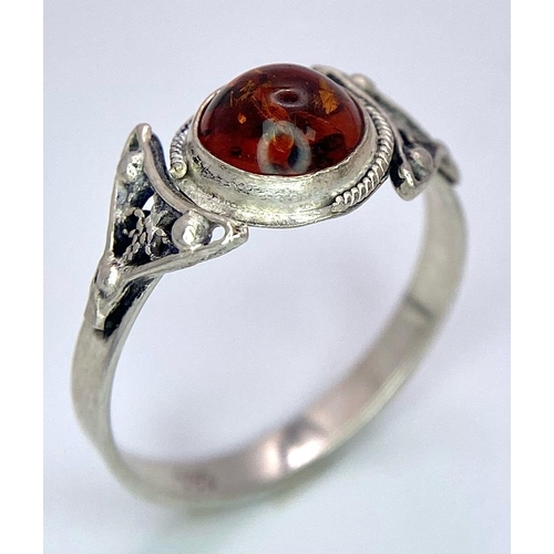 983 - A Sterling silver selection of 3 amber pieces, including 2 rings and a bracelet, 17.6g collective we... 