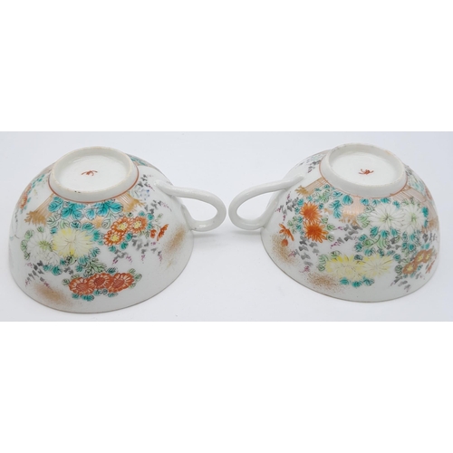 1548 - A pair of antique Japanese, hand-painted cup and saucer. 
Fine bone china with a delightful floral d... 