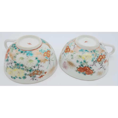 1548 - A pair of antique Japanese, hand-painted cup and saucer. 
Fine bone china with a delightful floral d... 