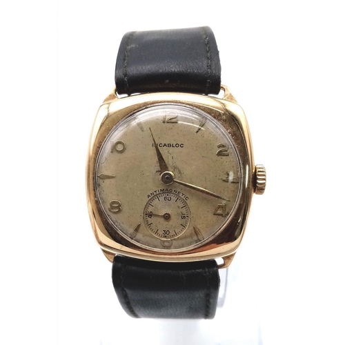 1387 - A Vintage 9K Gold Incabloc Gents Watch with a Courbelin Movement. 17 jewels. Black leather strap. 9k... 