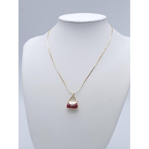 411 - An Italian 14k Yellow Gold Pendant in the Shape of a Handbag with Red Glitter Enamel Detailing on a ... 