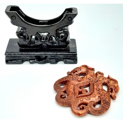 198 - A Chinese carved reddish brown jade amulet with a fascinating, highly detailed design of two dragons... 