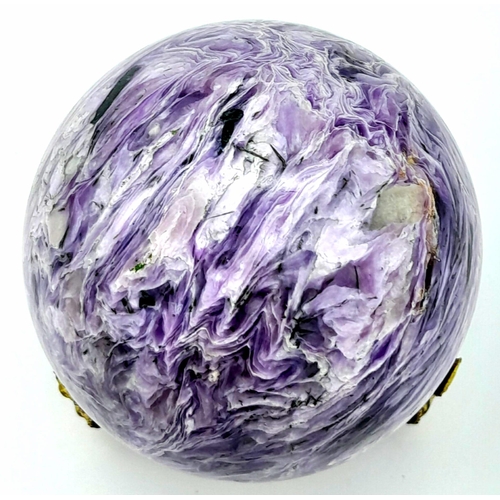 212 - A top quality, totally natural and undyed sphere of CHAROITE on a custom-made gilded metal base. Dia... 