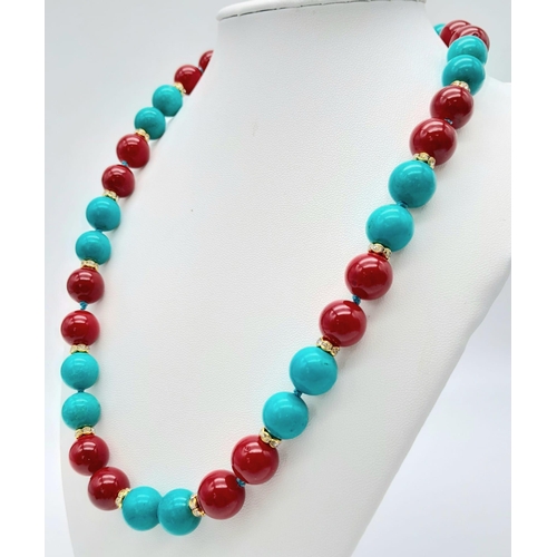 477 - A Vibrant Turquoise and Red Coral Bead Necklace. Gilded and white stone spacers. 12mm beads. 46cm ne... 