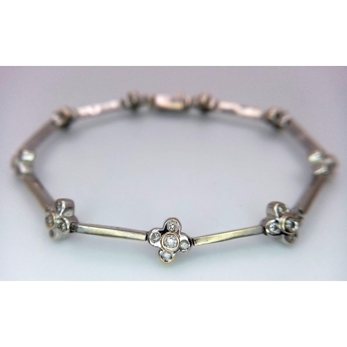 20 - A 14K WHITE GOLD DIAMOND SET IN THE FLORAL DESIGN BRACELET 0.60CT 10.3G 16.5cm length

ref: SC 1075