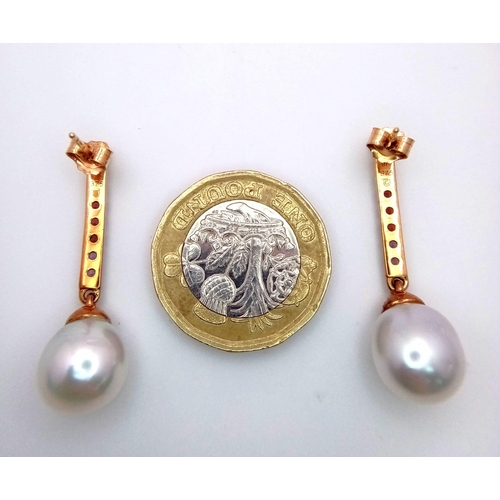 299 - A Pair of 9K Yellow Gold South Sea Pearl and Multi-Coloured Sapphire Drop Earrings. Comes with a det... 